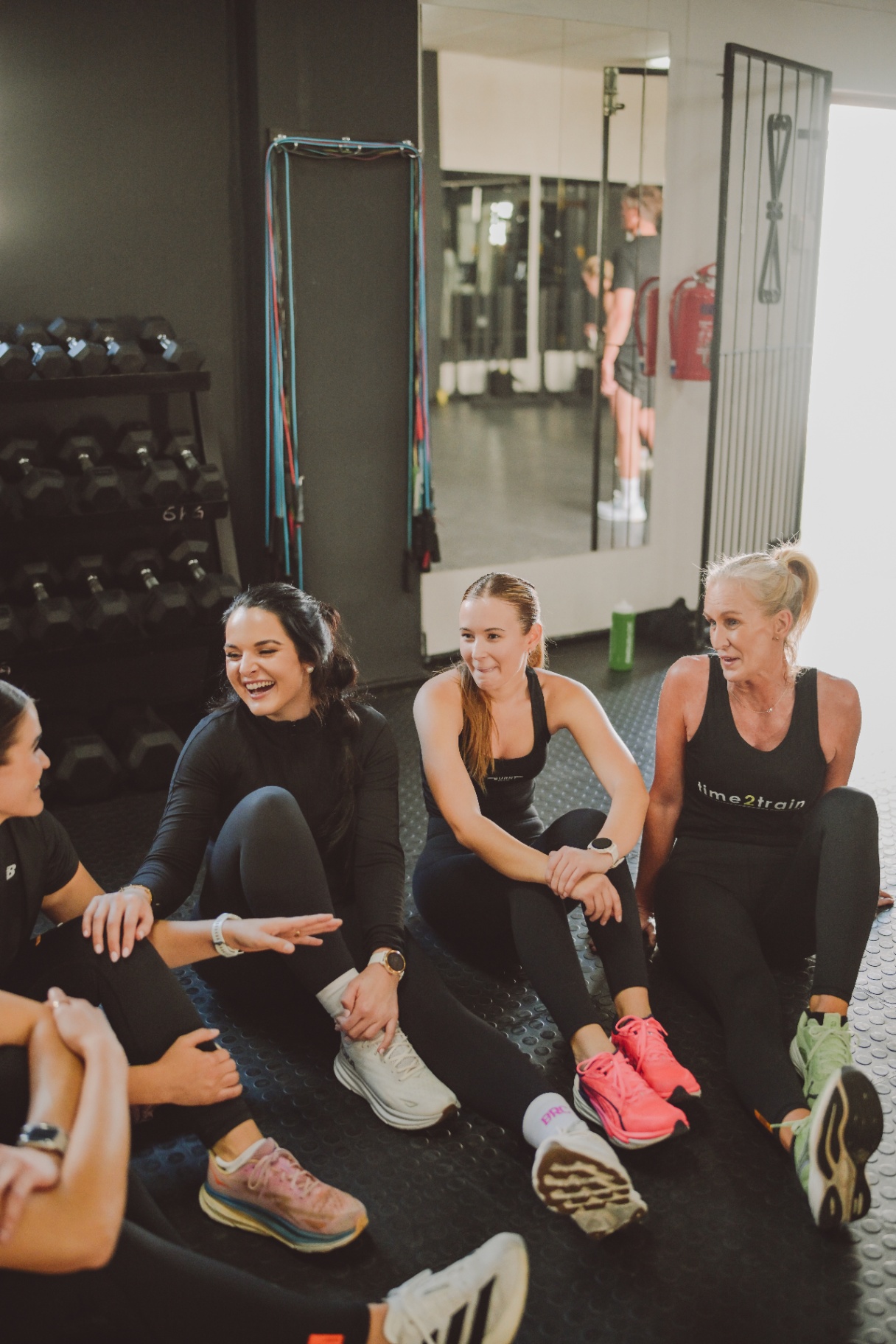 Members chatting and laughing after a class at Time2Train