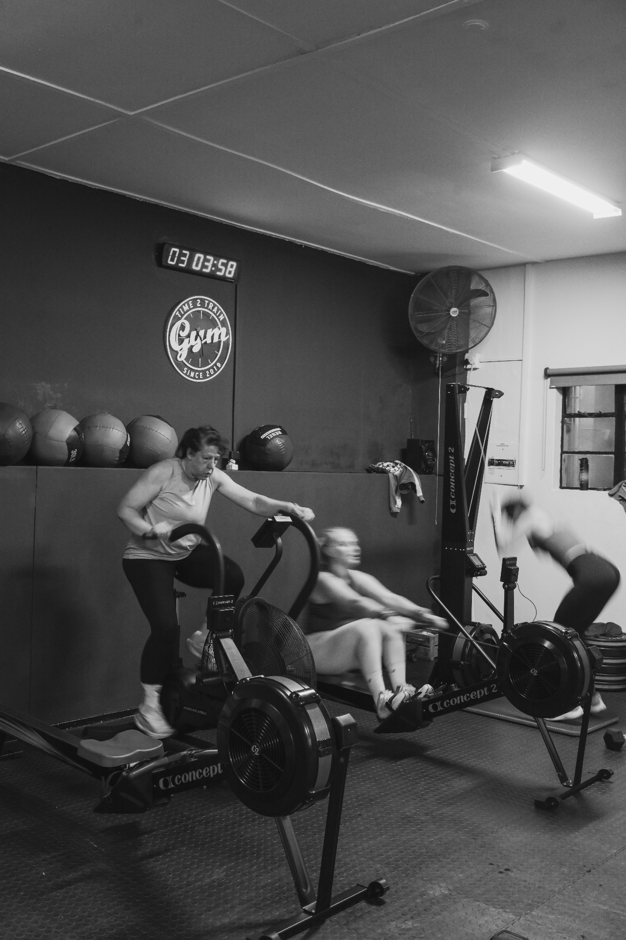 Members training on rowers and assault bikes at Time2Train