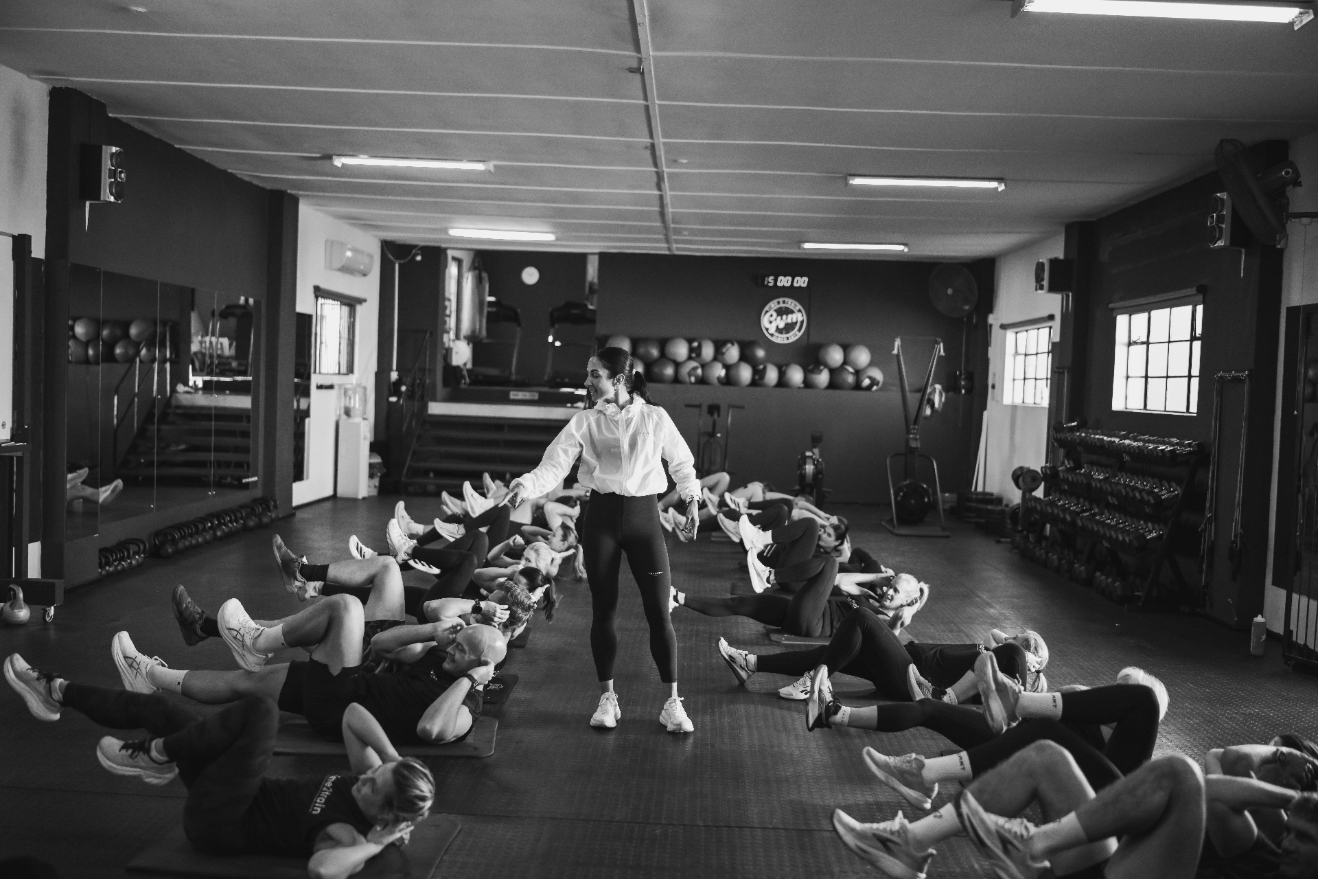 Coach leading a full group abs class at Time2Train